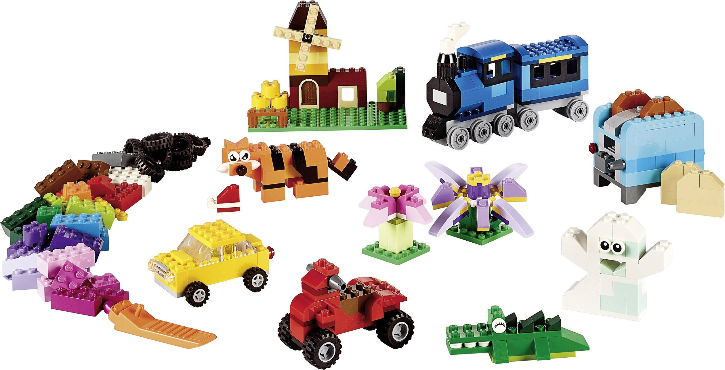 Forskellige farverige LEGO-konstruktioner, herunder et tog, en vindmølle, dyr og køretøjer, som viser kreative byggemuligheder.