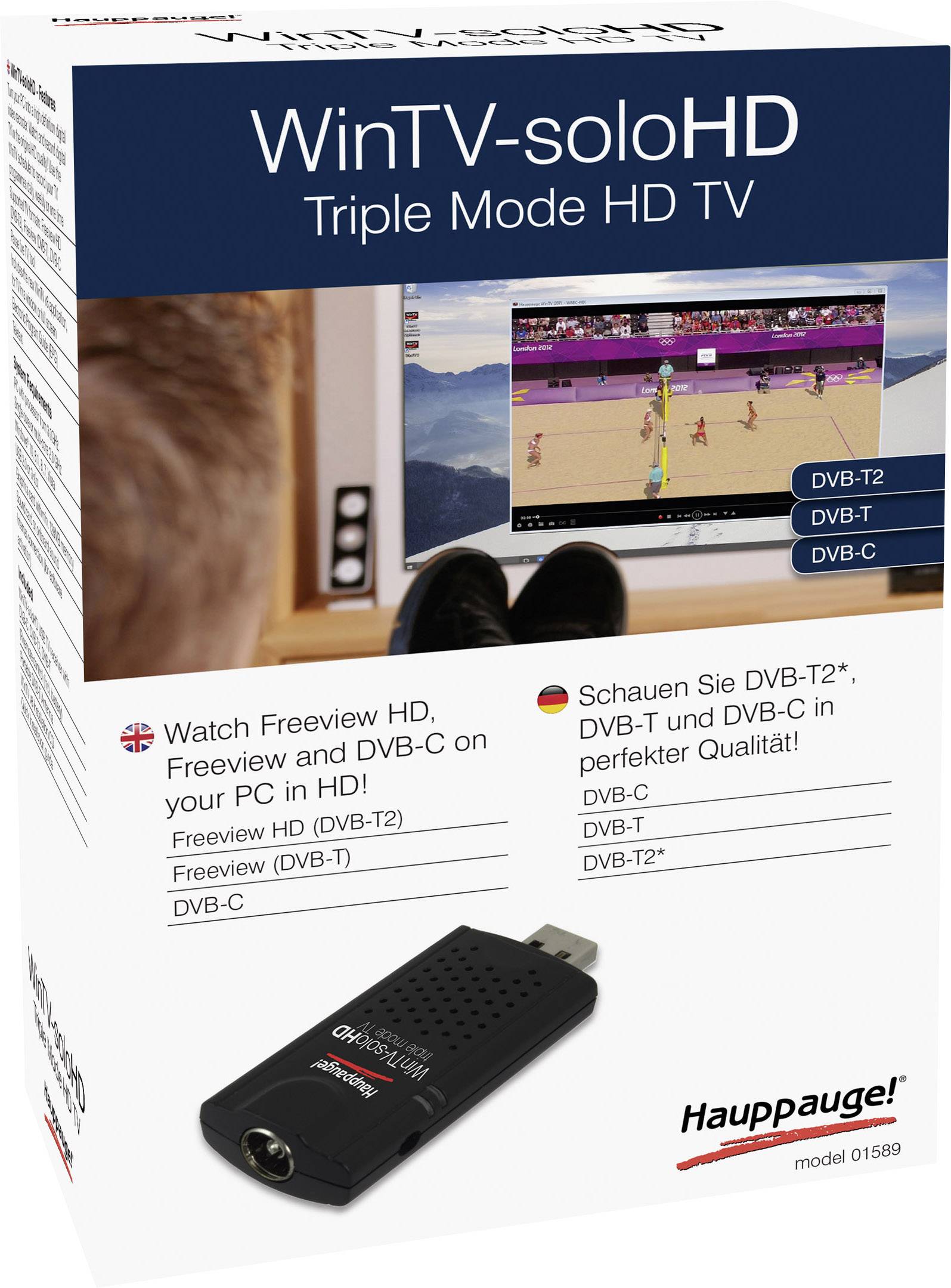 Emballage til en Hauppauge WinTV-soloHD USB-stick. Muliggør DVB-T2, DVB-C og Freeview HD-modtagelse på pc'er. Fjernsyn med landskab i baggrunden.