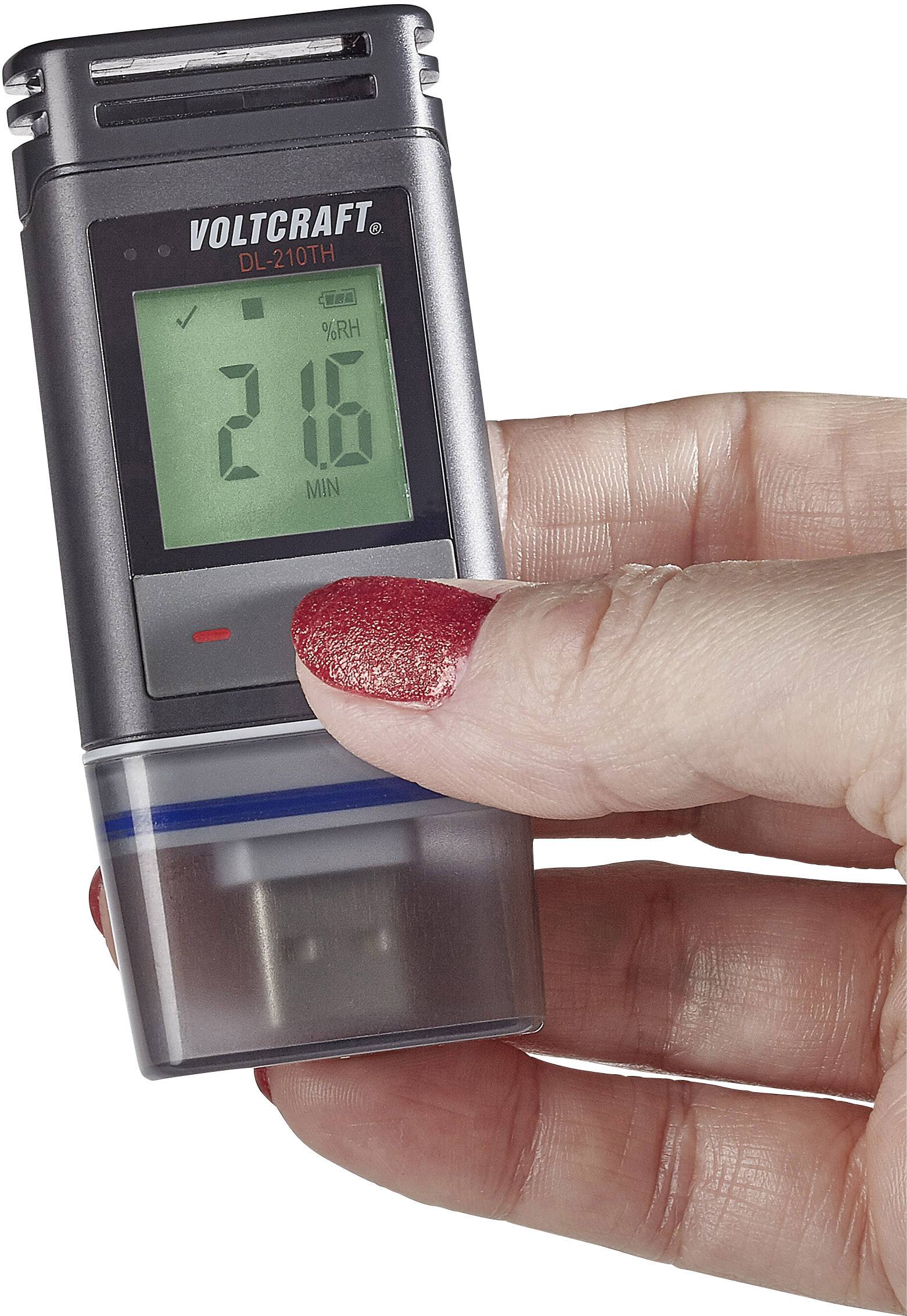 En hånd holder en elektronisk temperatur- og fugtighedsmåler af mærket Voltcraft DL-210TH, som viser '21,6'.
