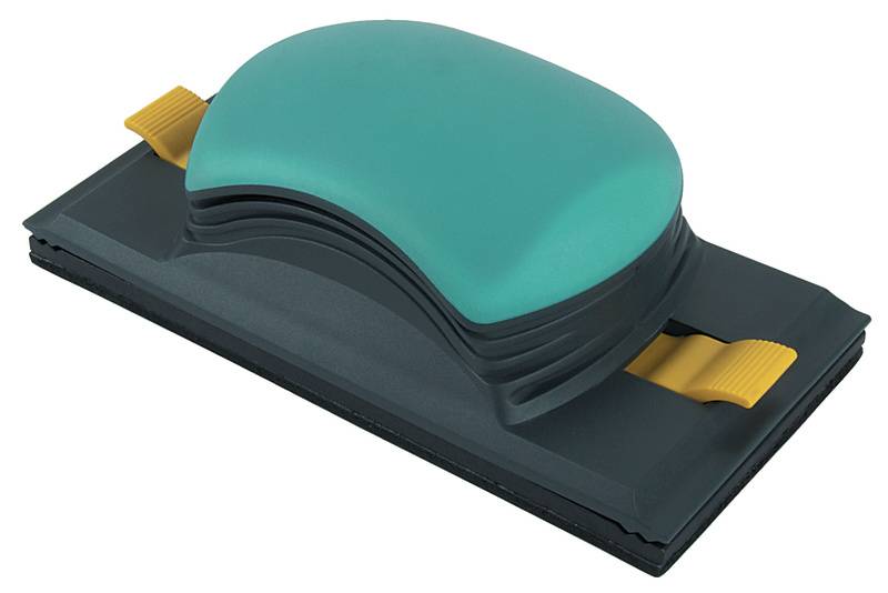 En håndslibeklods med grønt håndtag og sort underside; til venstre og højre to gule klemmearmene.