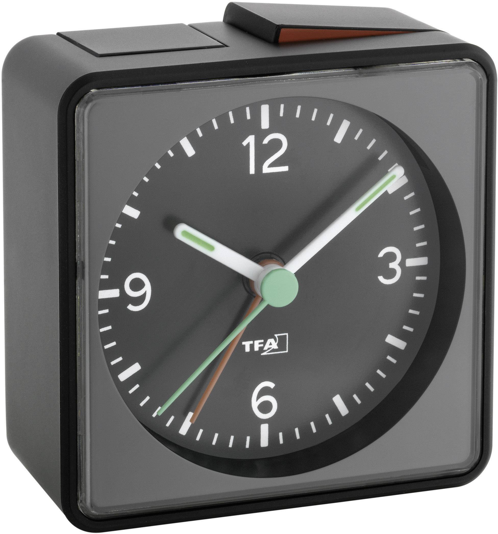 Et sort vækkeur med analog urskive viser klokkeslættet 10:10.