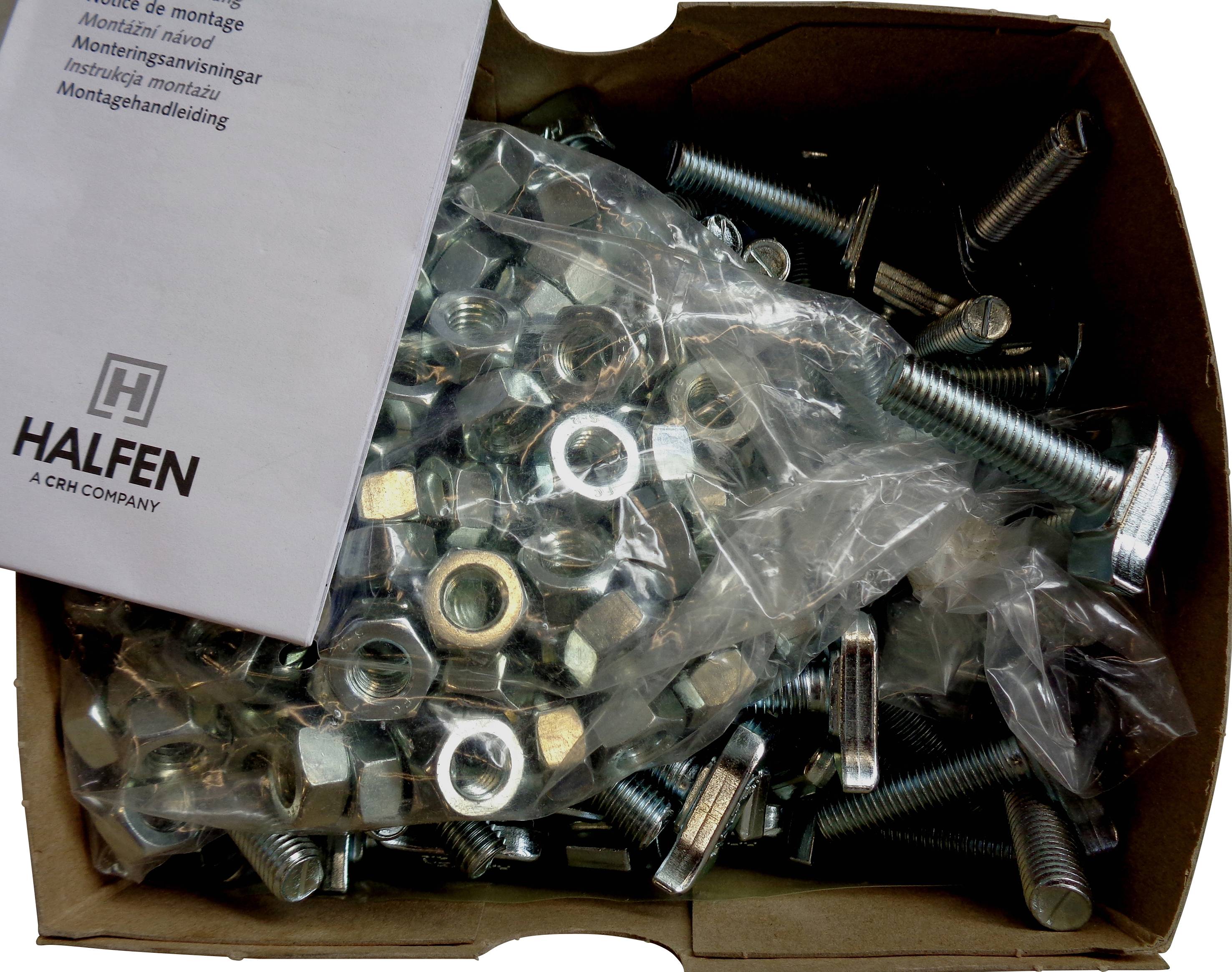 Ein Karton voller Schrauben und Muttern mit einem Handbuch auf Niederländisch, das Anweisungen zur Montage enthält.