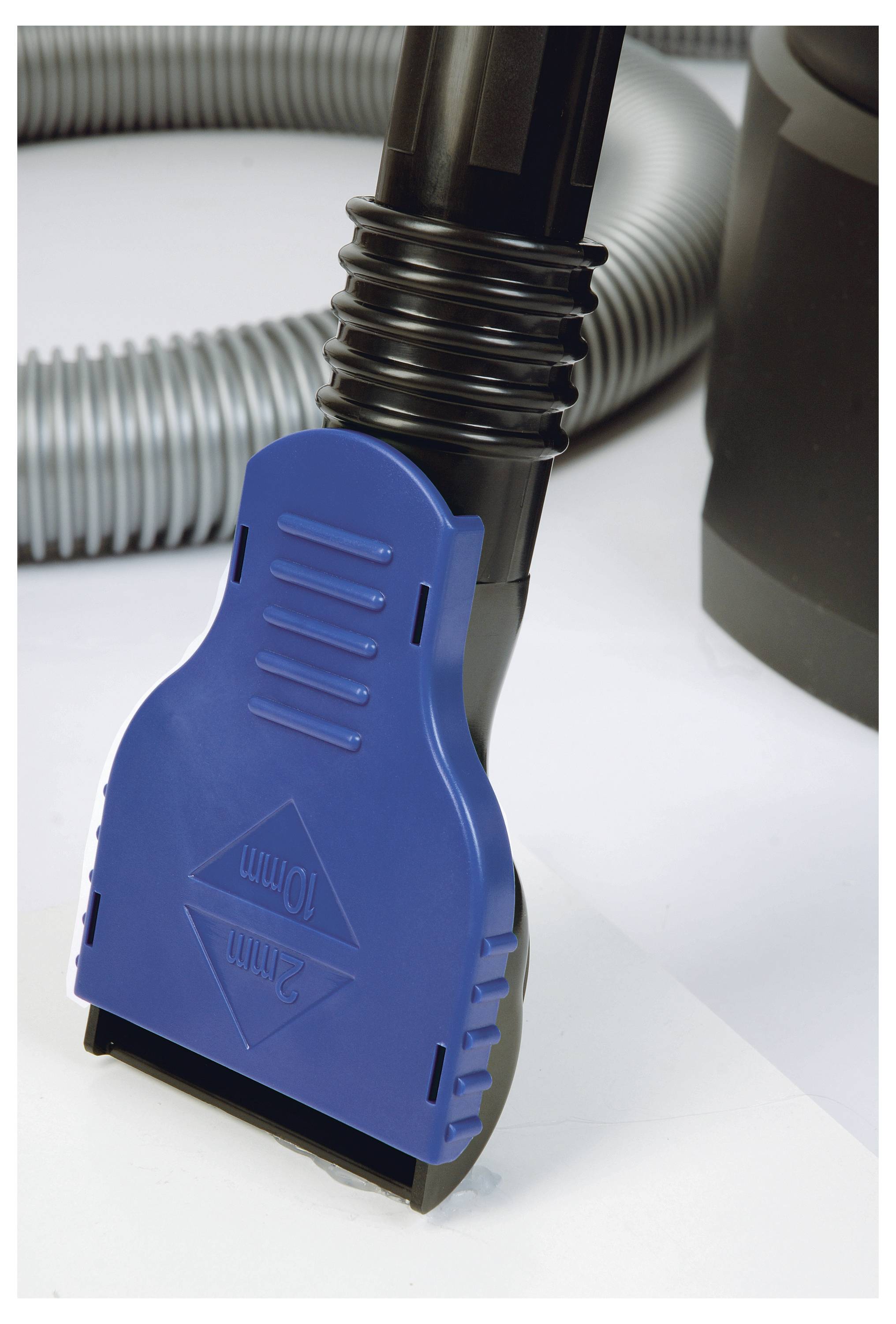 Blauer Kunststoffadapter für einen Staubsauger, der an einem flexiblen Schlauch befestigt ist; mit den Maßangaben '10 mm' und '32 mm' bedruckt.