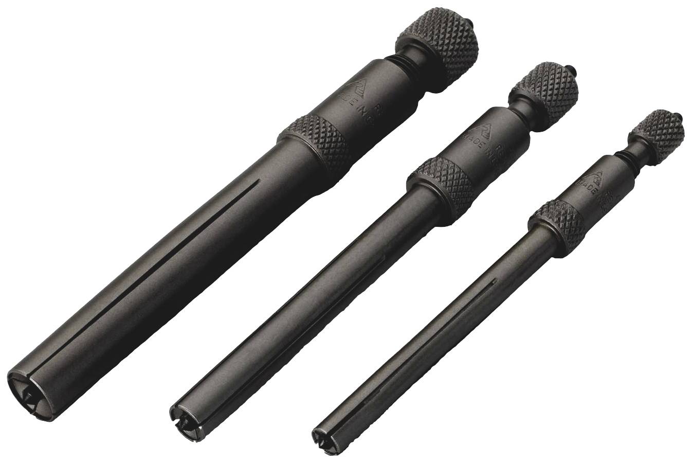 Drei schwarze Drehmeißel in verschiedenen Größen nebeneinander angeordnet auf weißem Hintergrund.