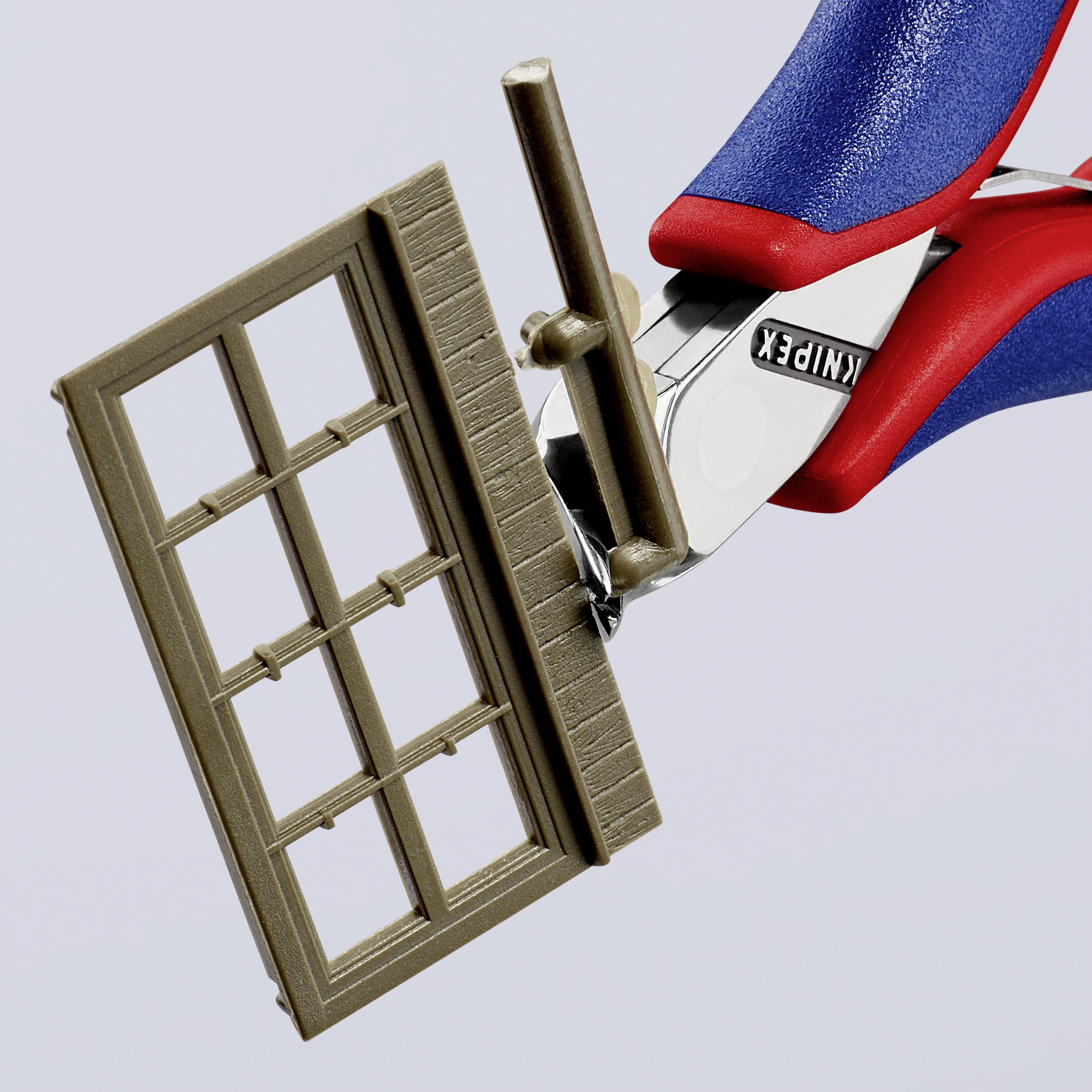 Zwei Hände halten einen Fensterrahmen mit Hilfe einer Klemme oder Zange mit blauem und rotem Griff, beschriftet mit 'KNIPEX'.