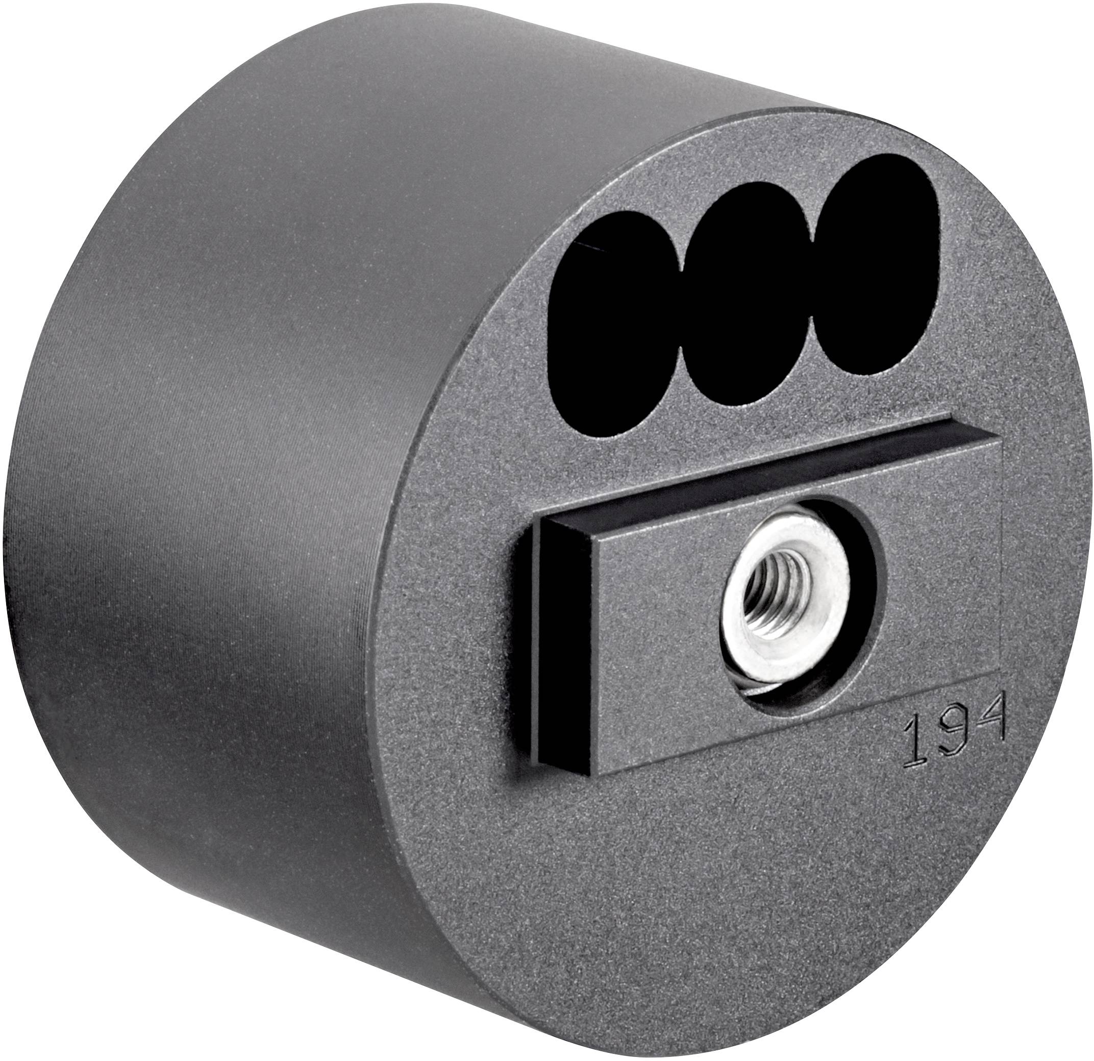 Ein runder, schwarzer Adapter mit drei Löchern und einer zentralen Metallbefestigung.
