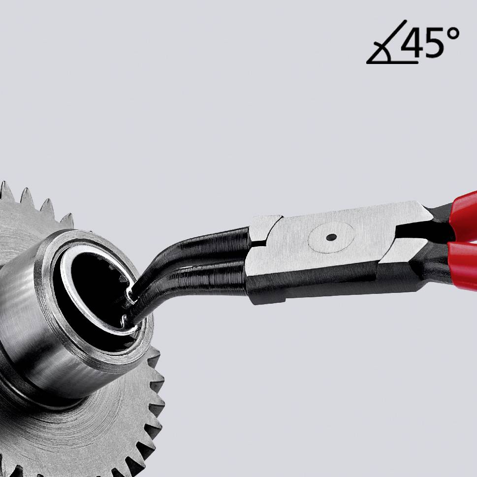 Eine Zange hält ein Kabel, das durch eine Metallzahnung mit einem Winkel von 45 Grad verläuft.