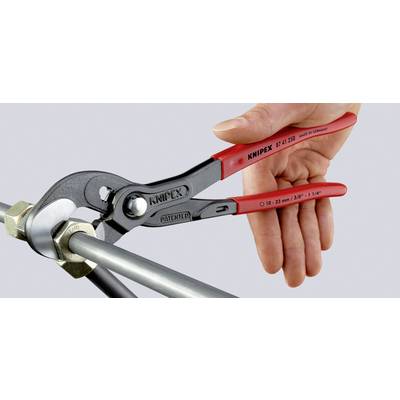 Eine Hand benutzt eine rote Knipex Zange, um eine Mutter an einem Metallrohr zu drehen.