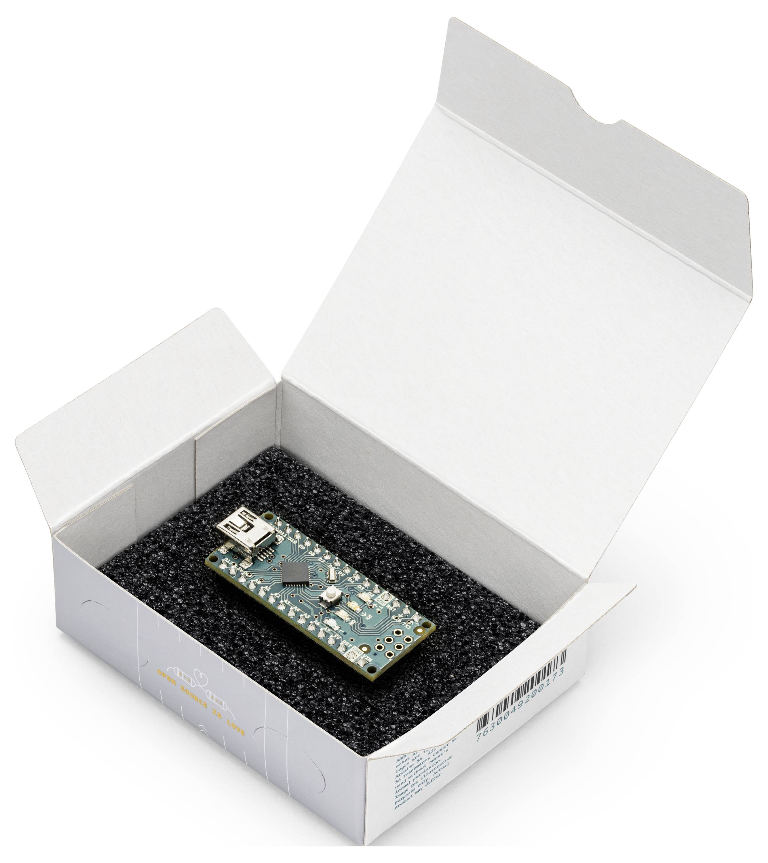 Eine kleine Leiterplatte ruht in einer schaumstoffgepolsterten weißen Produktbox mit geöffnetem Deckel auf einem einfachen Hintergrund.