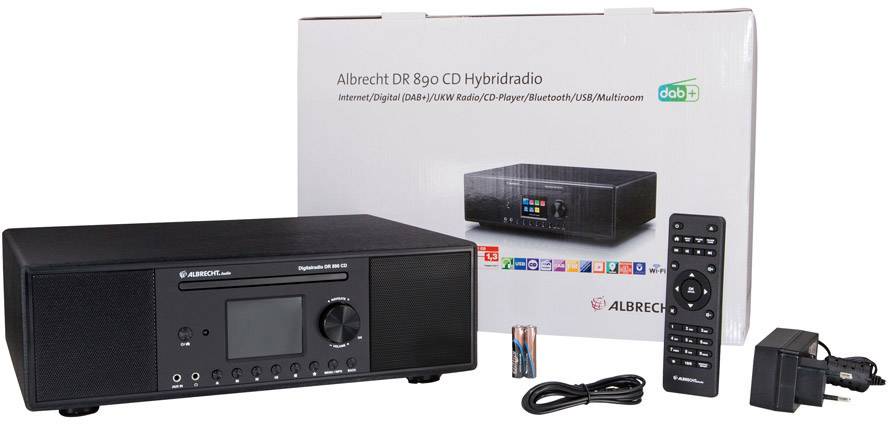 'Radio- und CD-Player-Kombination auf einem Tisch, Albrecht DR 890 CD Hybridradio, mit Fernbedienung und Verpackung im Hintergrund.'