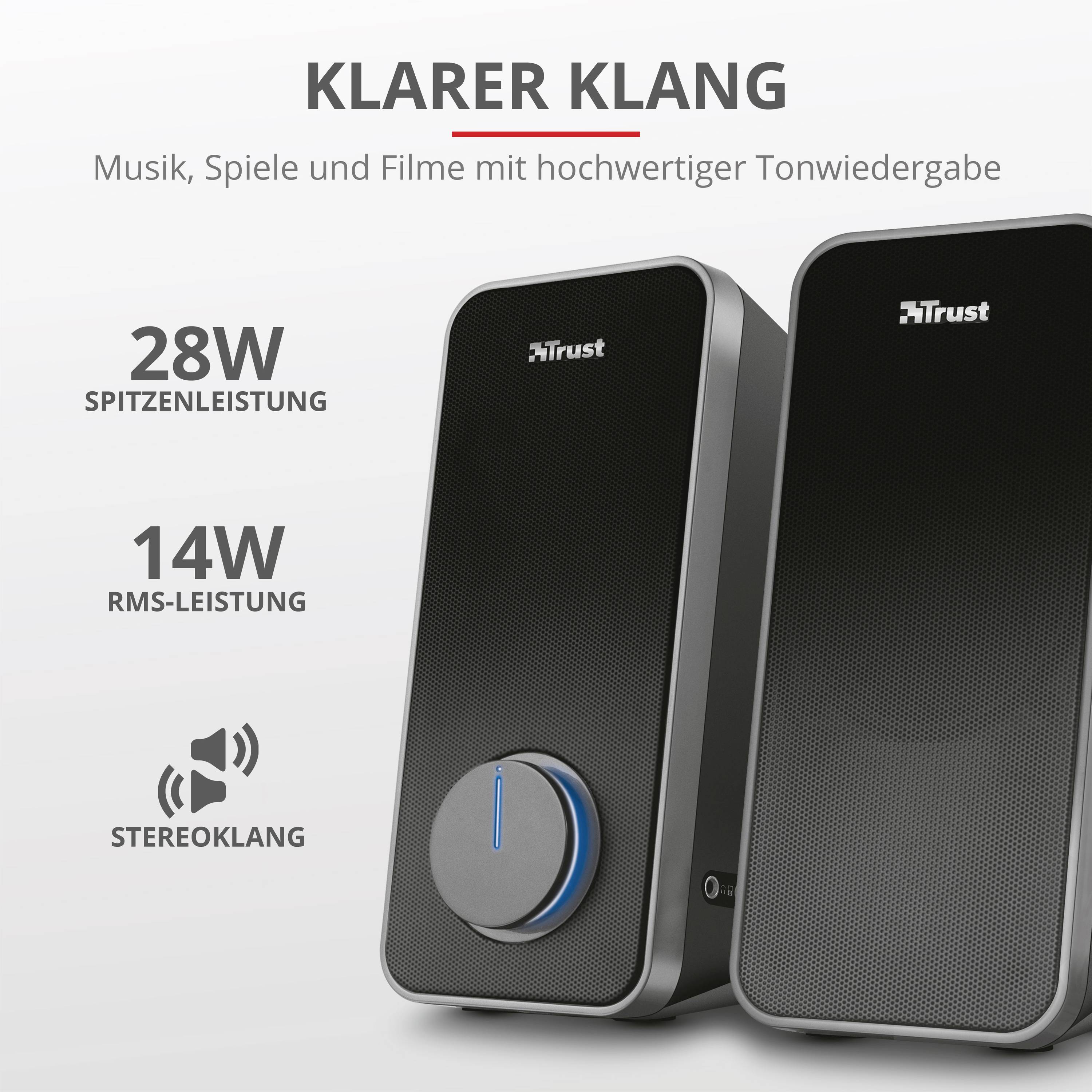 Zwei schwarze Lautsprecher mit Trust-Logo. Text oben: 'Klarer Klang'. Leistungsangaben: '28W Spitzenleistung', '14W RMS-Leistung'.