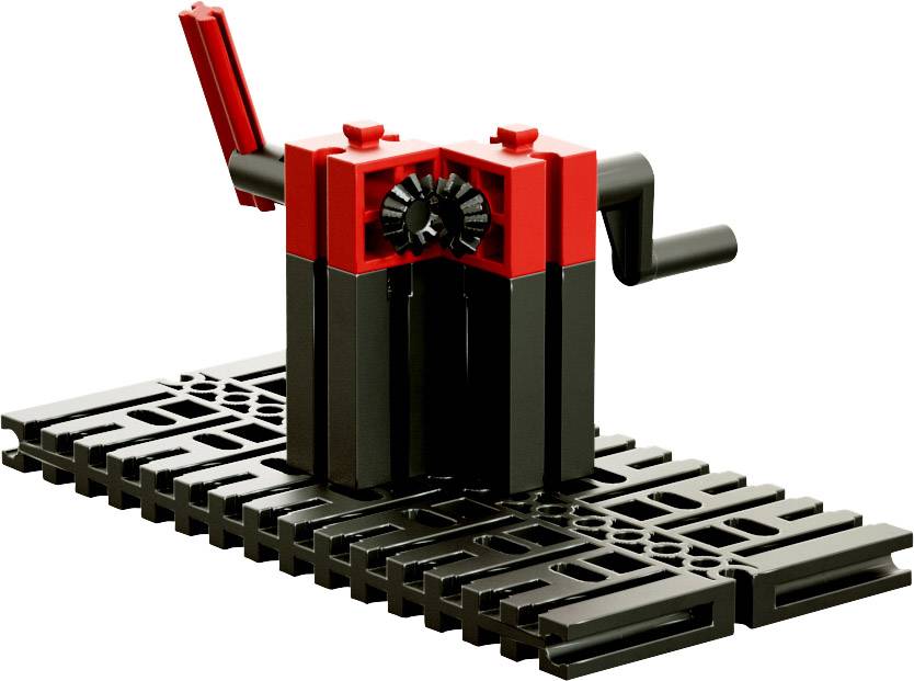 Rotes und schwarzes mechanisches Spielzeug auf schwarzer Basis mit beweglichen Teilen und Hebeln, das technische Kreativität fördert.