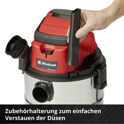Staubsauger mit Zubehörhalterung; eine Hand legt Düse ein. Funktion: einfaches Verstauen der Düsen.