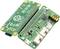 Zwei grüne Platinen: Links das Raspberry Pi Zero Board mit Logos, rechts ein Erweiterungsboard mit Anschlüssen und Schalter.