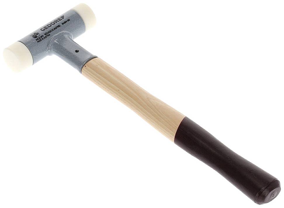Ein Hammer mit hölzernem Griff und Kunststoffköpfen an beiden Enden liegt schräg. Geeignet für sanfte Schläge.