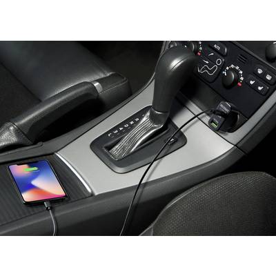 Ein Smartphone wird im Auto aufgeladen. Es ist mit einem Kabel an die USB-Buchse neben dem Schalthebel angeschlossen.