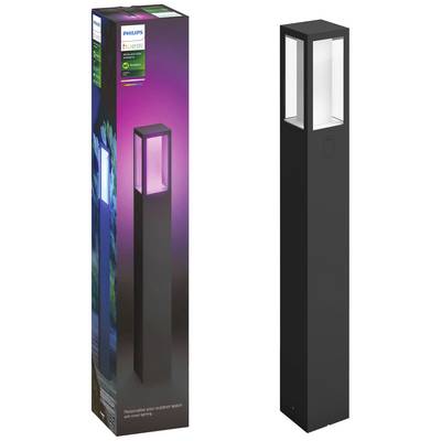 Eine schwarze Philips Hue Außenleuchte neben ihrer Verpackung. Die Verpackung zeigt Farbwechsel-Optionen und das Philips Hue-Logo.