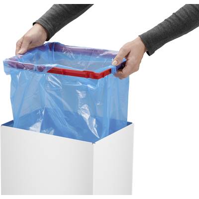 Person zieht einen blauen Müllbeutel in einen weißen Mülleimer. Hände greifen die Beutelöffnung und sichern sie in der Mülltonne.
