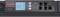 Ein Rack-PDU von APC mit digitalem Display, zeigt Eingangsleistung an. Geräteanschlüsse und Bedientasten sind sichtbar.