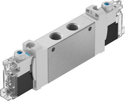 Ein rechteckiges Metallventil mit zwei kreisförmigen Anschlüssen oben und transparenten Endkappen an beiden Seiten. 