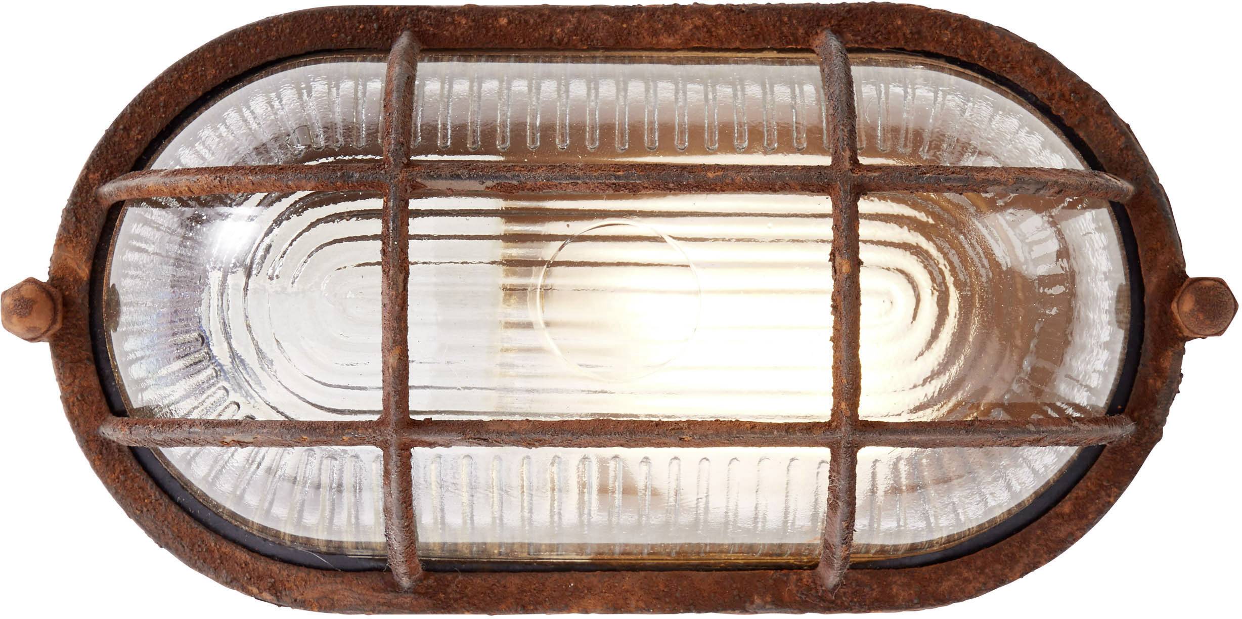 Elliptische Wandlampe im Industriedesign, mit rostfarbenem Metallgitter und Glasabdeckung, leuchtet warmes Licht aus.