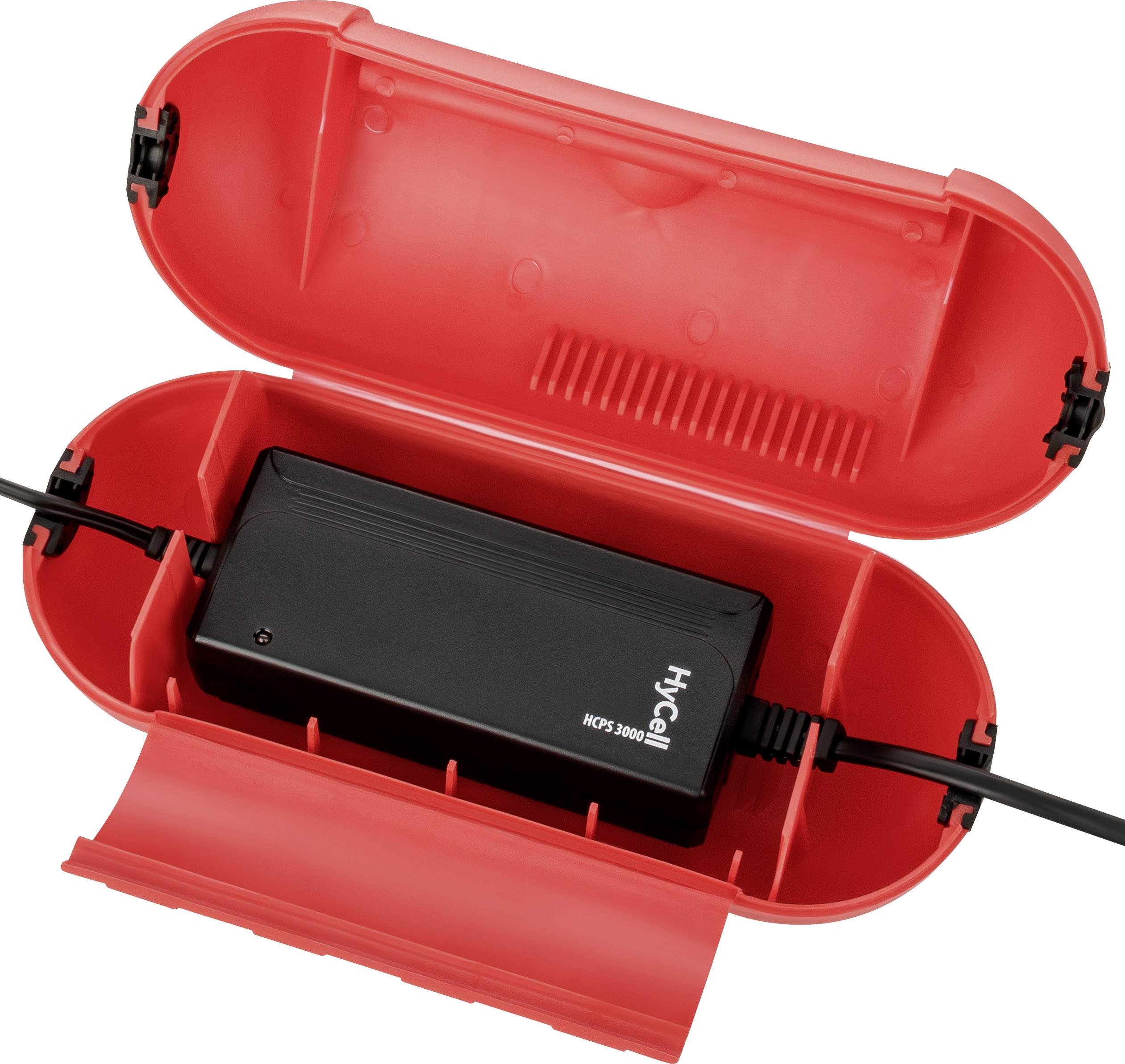 Ein rechteckiger, schwarzer Block in einem geöffneten, roten Gehäuse mit Kabeln an beiden Enden.