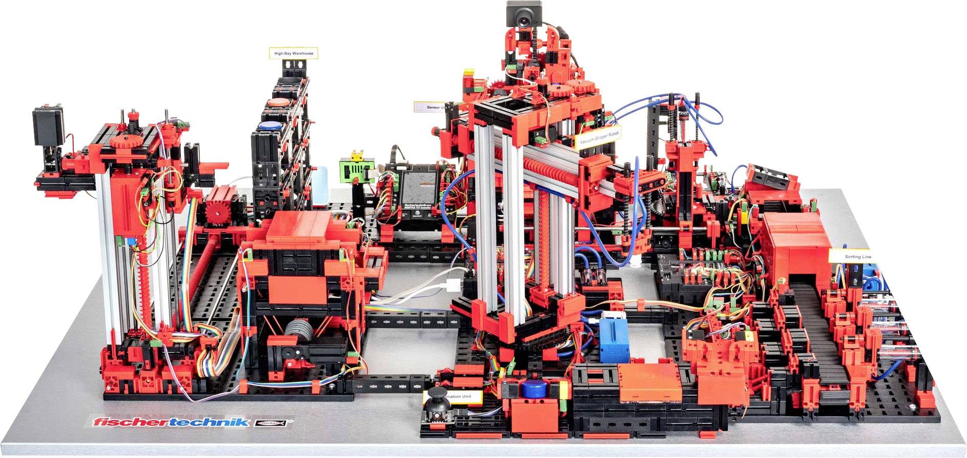 Eine komplexe Maschine mit robusten, roten und schwarzen Bauteilen, verdrahtet und mechanisiert, auf einer grauen Basis montiert.