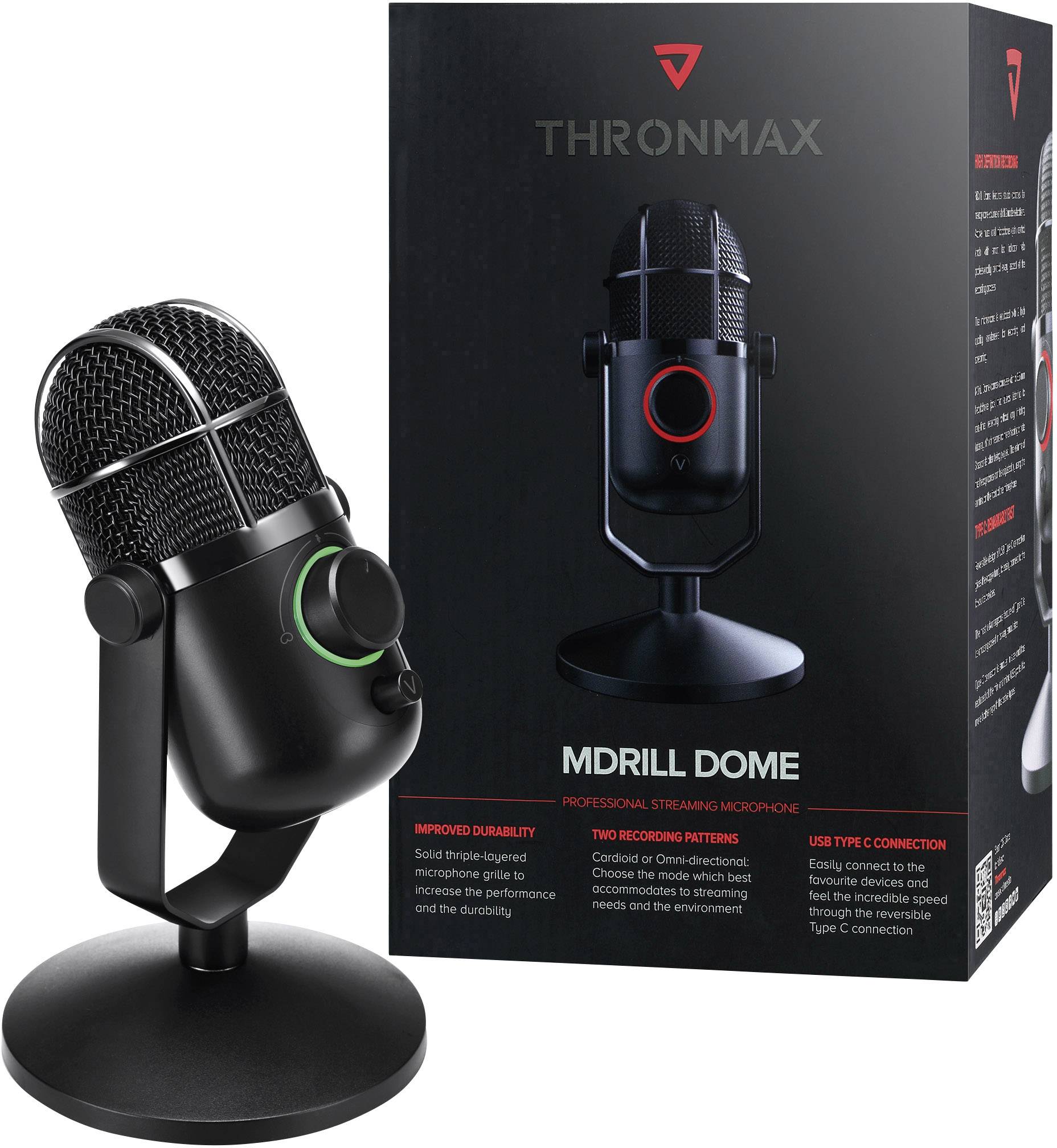 'Mikrofon Thronmax MDrill Dome' abgebildet neben seiner Verpackung. Schwarzes Design, grüne Akzentbeleuchtung, passend für Podcasting.