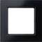 Schwarzer quadratischer Rahmen mit einem weißen Innenraum, geeignet für diverse Schalter oder Steckdosenmontage.