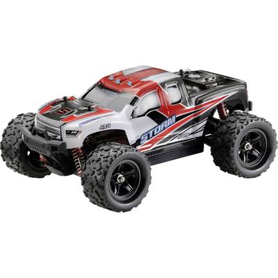 Ein ferngesteuertes Auto mit robusten Reifen und rotem, grauem Design; aufgedruckt 'STORM'. Geeignet für Offroad-Bedingungen.