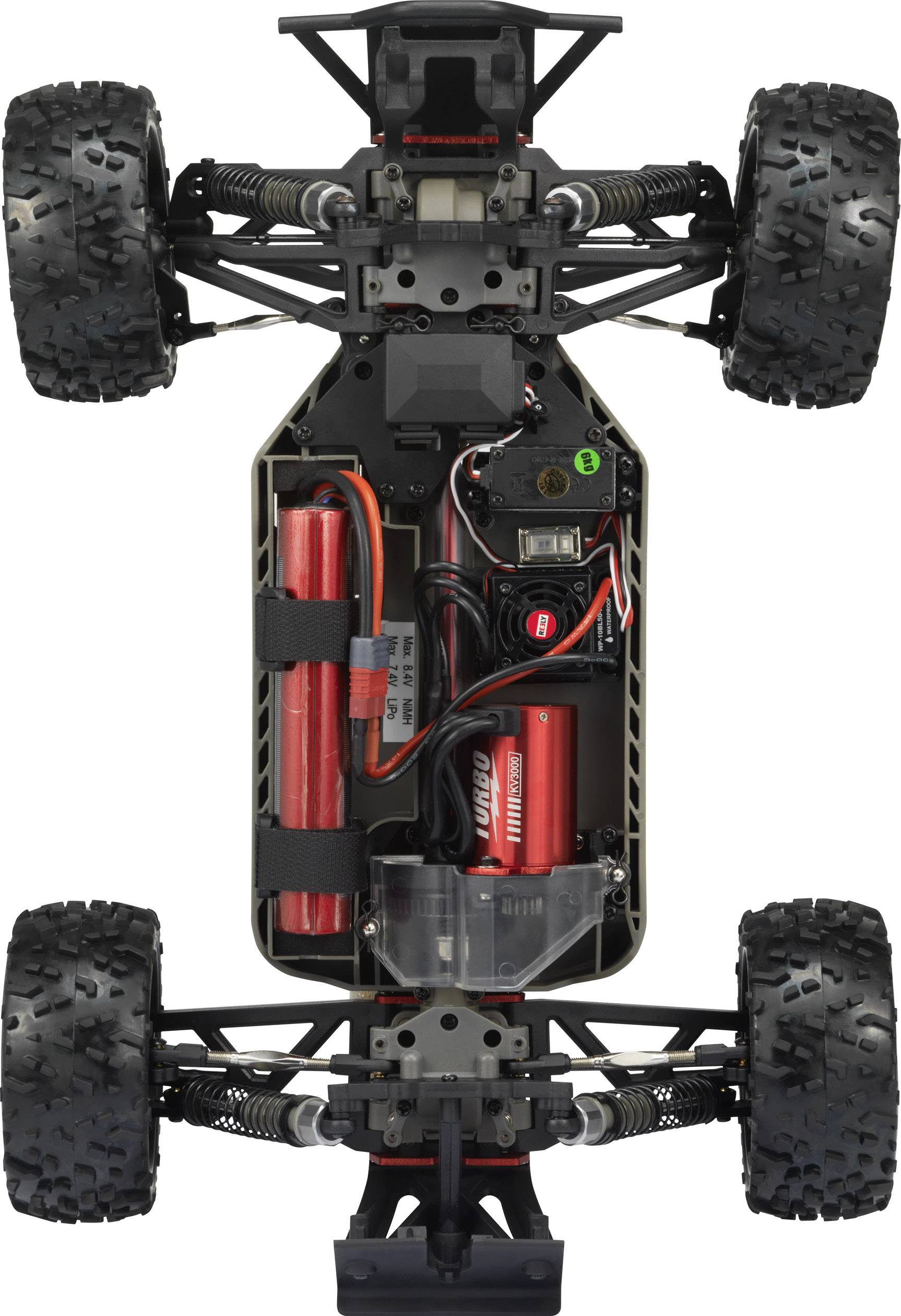 'Obere Ansicht eines RC-Auto-Chassis mit Elektronik, Batterien und offenen Radaufhängungen. Robuste, profilierte Reifen sind sichtbar.'