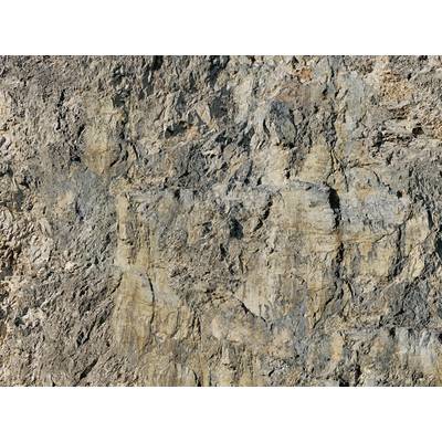 Steinige Felswand mit verschiedenen Grautönen und Texturen, zeigt natürliche Erosionsmuster.