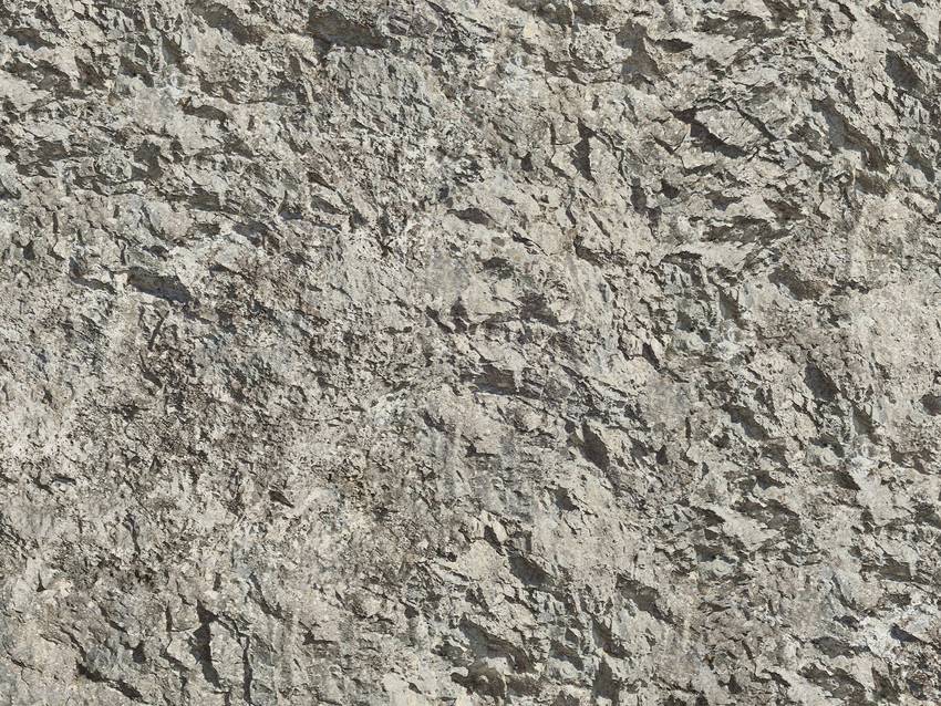 Rauhe graue Steinwand mit unregelmäßiger Textur; detailreiche Oberfläche.