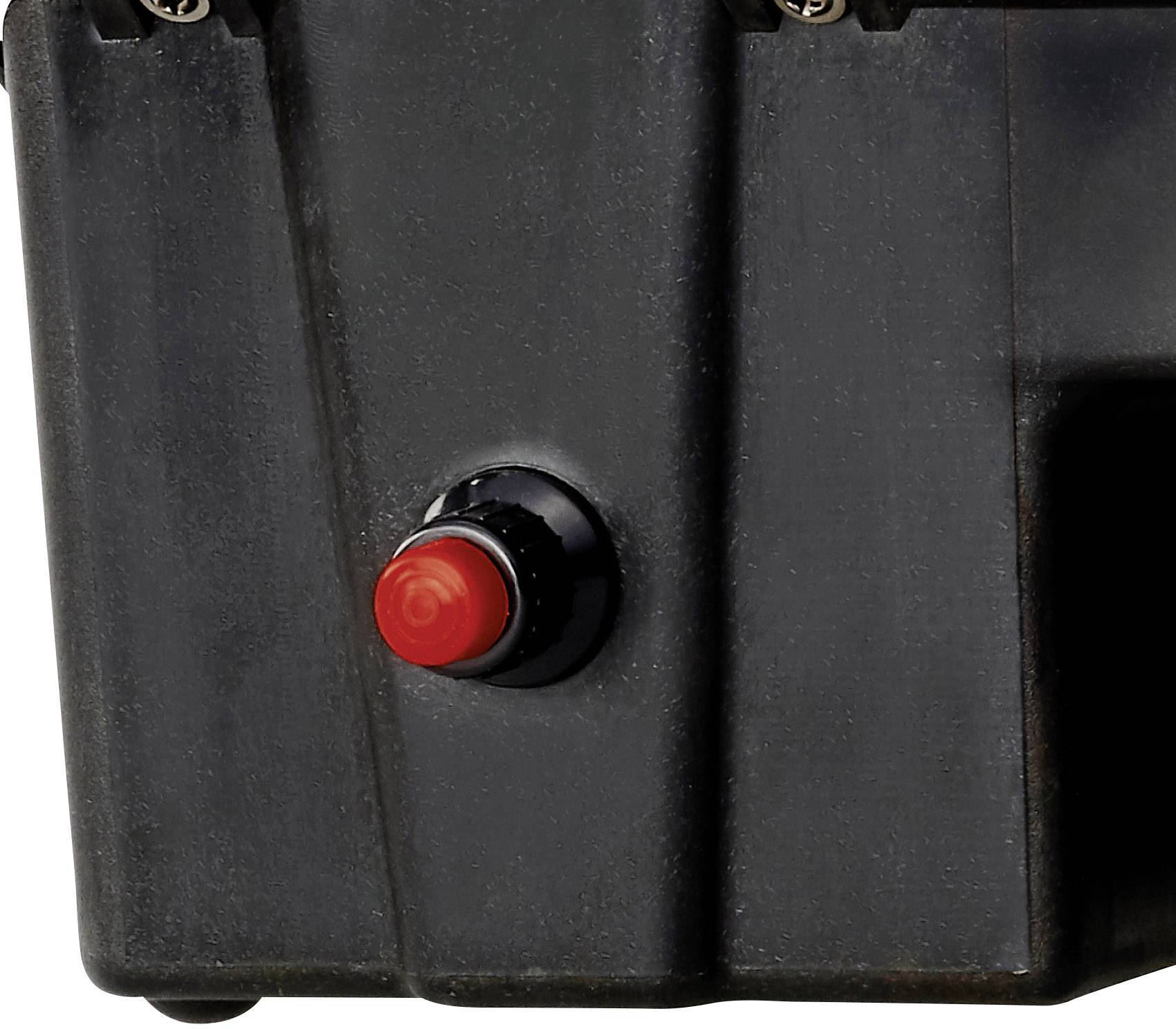 Ein roter Not-Aus-Knopf auf einem schwarzen Gerät. Er ist gut erreichbar platziert und dient zur schnellen Abschaltung im Notfall.