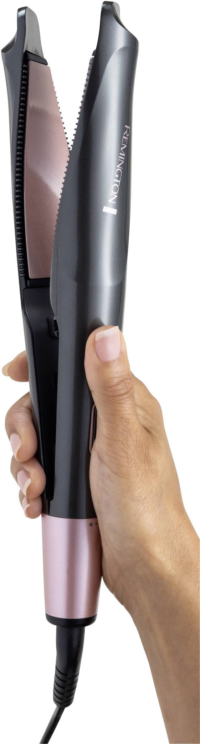 Eine Hand hält einen schwarzen und rosafarbenen Haarglätter.