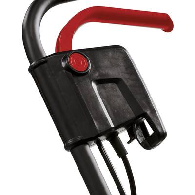 Nahaufnahme eines schwarzen Griffs mit rotem Hebel an einem Gerät. Der Hebel ist in der Aufwärtsposition, möglicherweise ein Sicherheitsmechanismus.