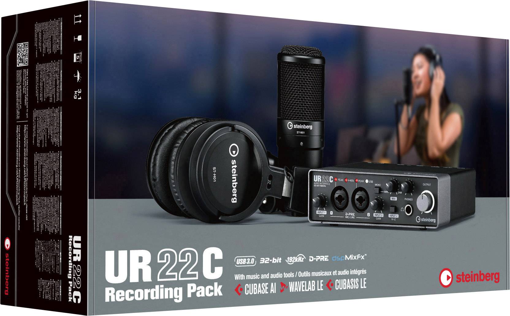 'Steinberg UR22C Recording Pack' Box mit Audio-Interface, Kopfhörer und Mikrofon abgebildet. Frau singt im Hintergrund.
