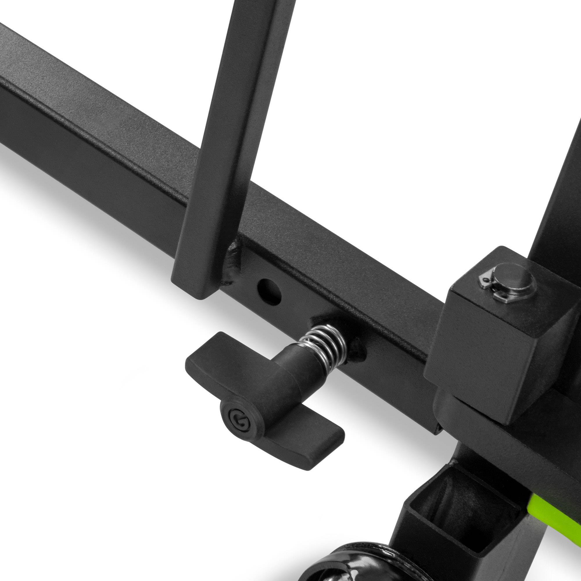 Nahaufnahme eines schwarzen Fitnessstudio-Geräts mit Schrauben und Hebel, teilweise montiert, fokussiert auf einstellbare Mechanik.