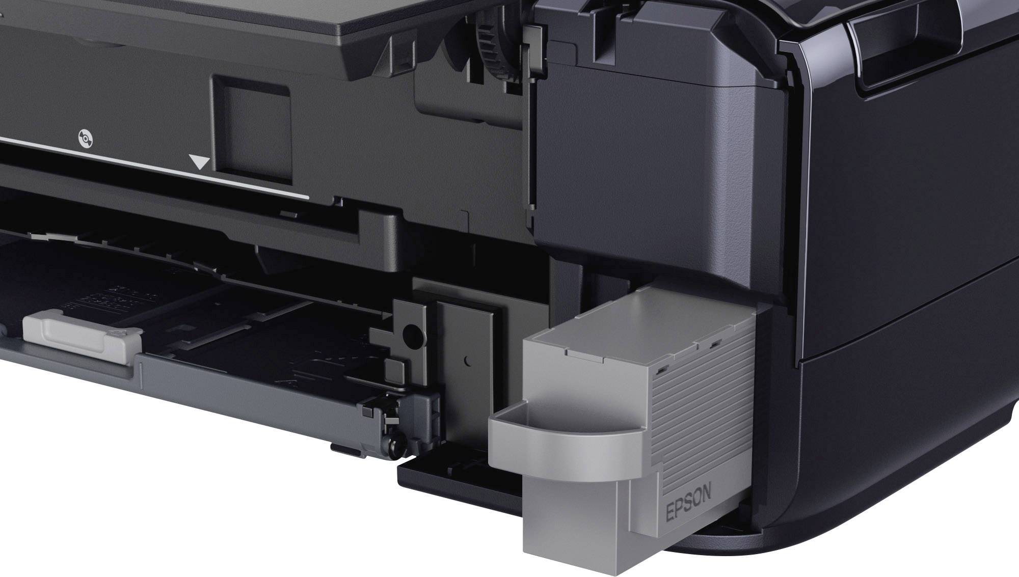 Ein geöffneter Tintenstrahldrucker mit sichtbarer Papierkassette und einer herausnehmbaren Tintenpatrone rechts daneben.