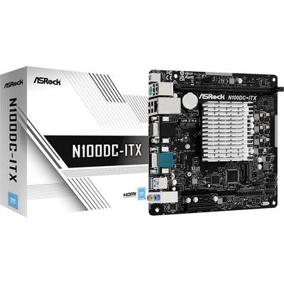 'ASRock N100DC-ITX Mainboard' neben seiner Verpackung gezeigt. Auf dem Mainboard sind verschiedene Anschlüsse und ein großer Kühlkörper sichtbar.