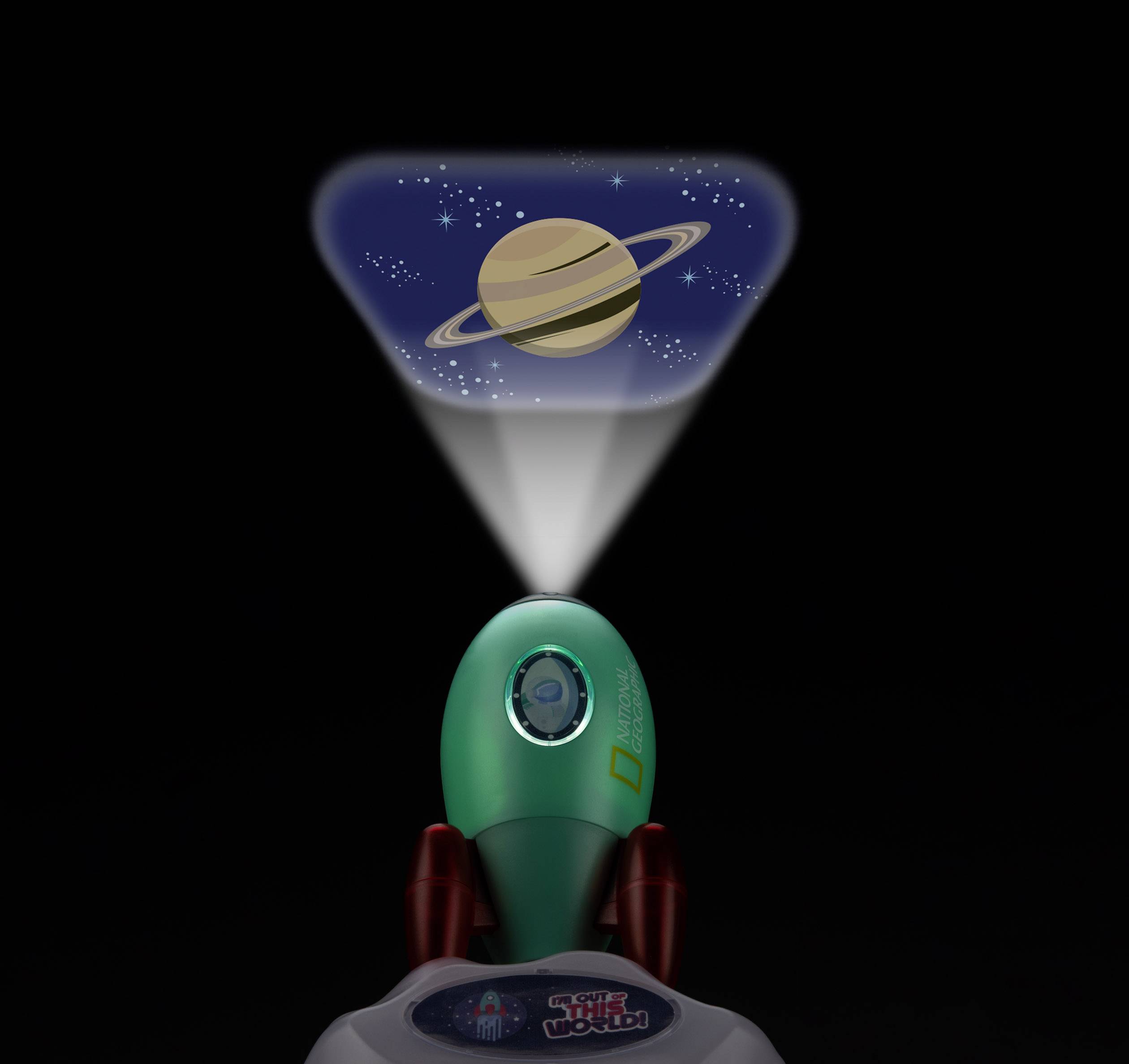 Ein grünes Spielzeug in Raketenform projiziert das Bild eines Planeten mit Ringen auf eine Wand, das an Saturn erinnert.
