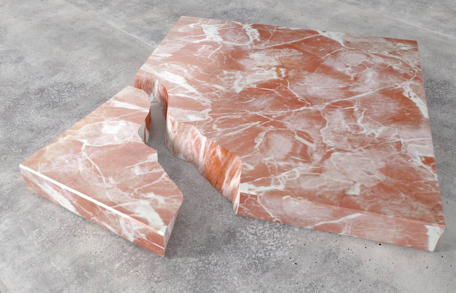 Ein großes, rosafarbenes Marmorstück mit einer abgebrochenen Ecke liegt auf einem grauen Untergrund.