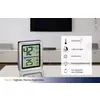 Digitales Thermo-Hygrometer auf einem Tisch. Zeigt 42% Luftfeuchtigkeit und 25°C. Icons rechts: Temperatur, Luftfeuchtigkeit, Komfortzone.