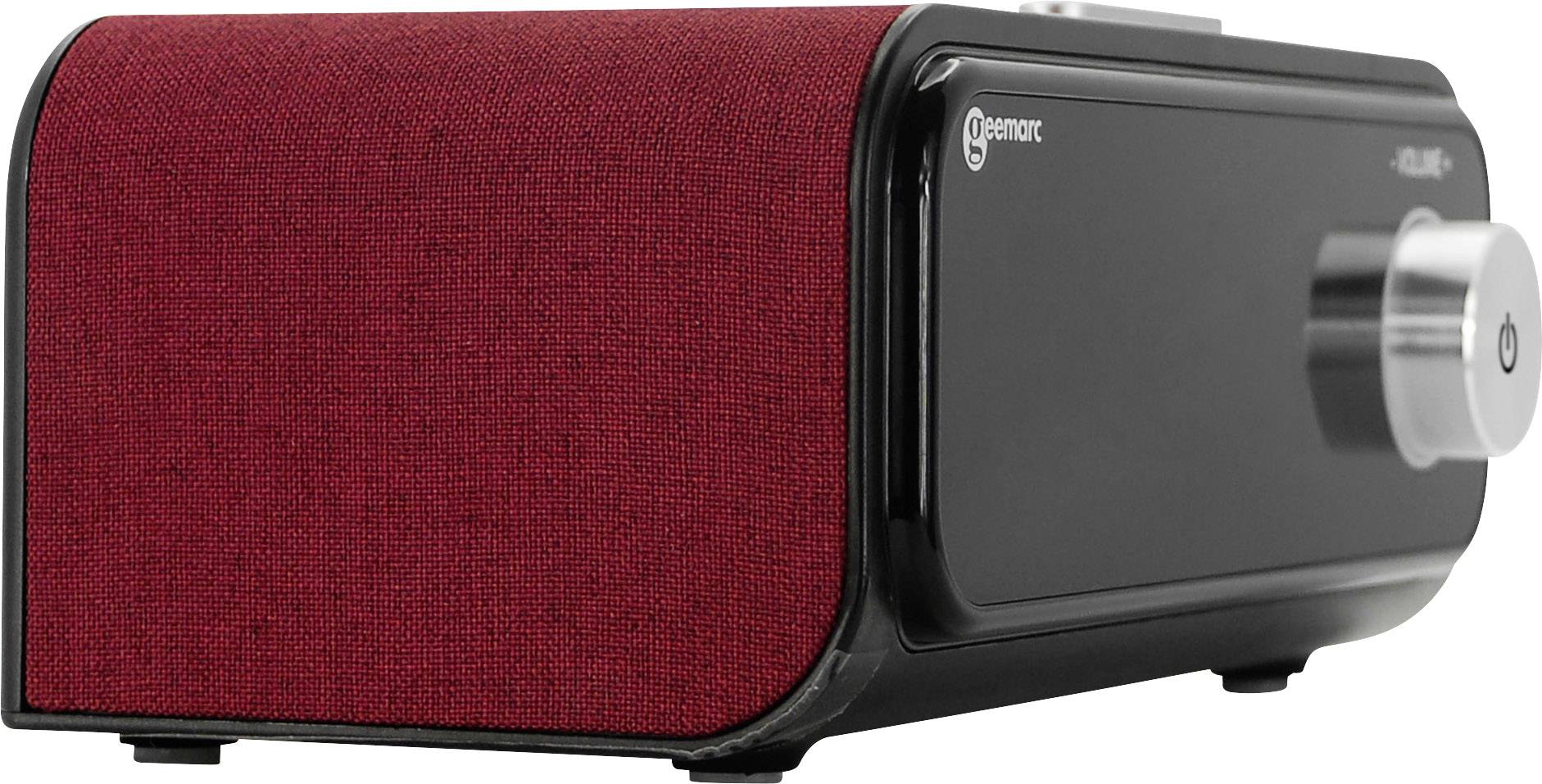 Ein stilvoller schwarzer Lautsprecher mit roter Stoffabdeckung und silbernem Einstellknopf an der Seite; modernes Design.