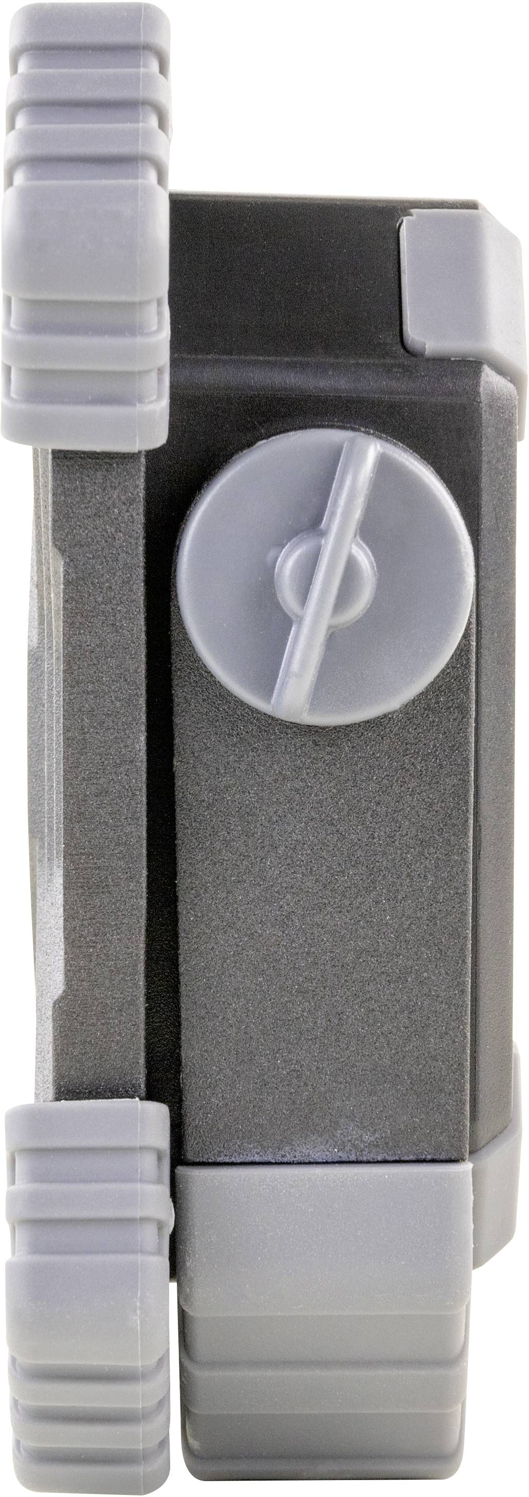 Ein graues, rechteckiges Objekt mit einem großen, runden Drehknopf in der Mitte, flankiert von zwei senkrechten rutschfesten Griffen.