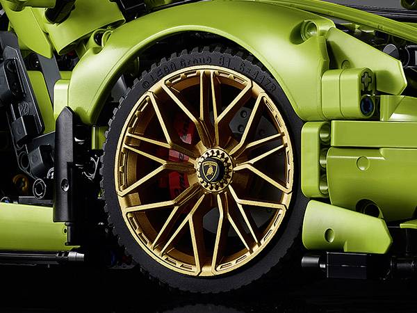 Ein grünes Modellauto zeigt ein goldenes Rad mit klar erkennbaren Details. Das Design wirkt modern und sportlich.