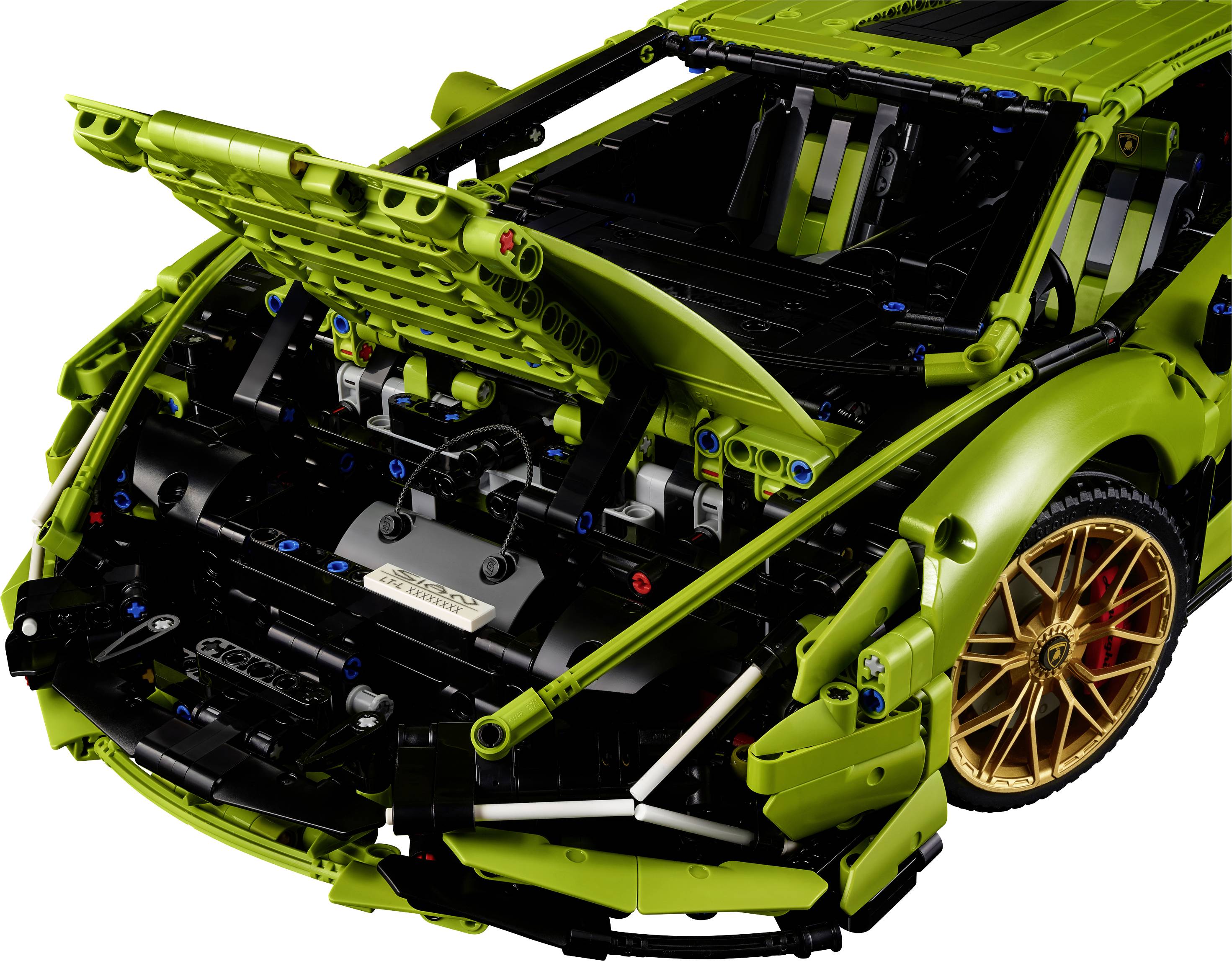 Ein grünes LEGO-Modellauto mit geöffneter Motorhaube zeigt detaillierte Innenmechanik; goldene Felgen ergänzen das Design.