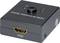 HDMI-Umschalter mit vier Ecken, Schalter in der Mitte, zwei Ports oben gekennzeichnet mit '1' und '2', HDMI-Anschluss unten.