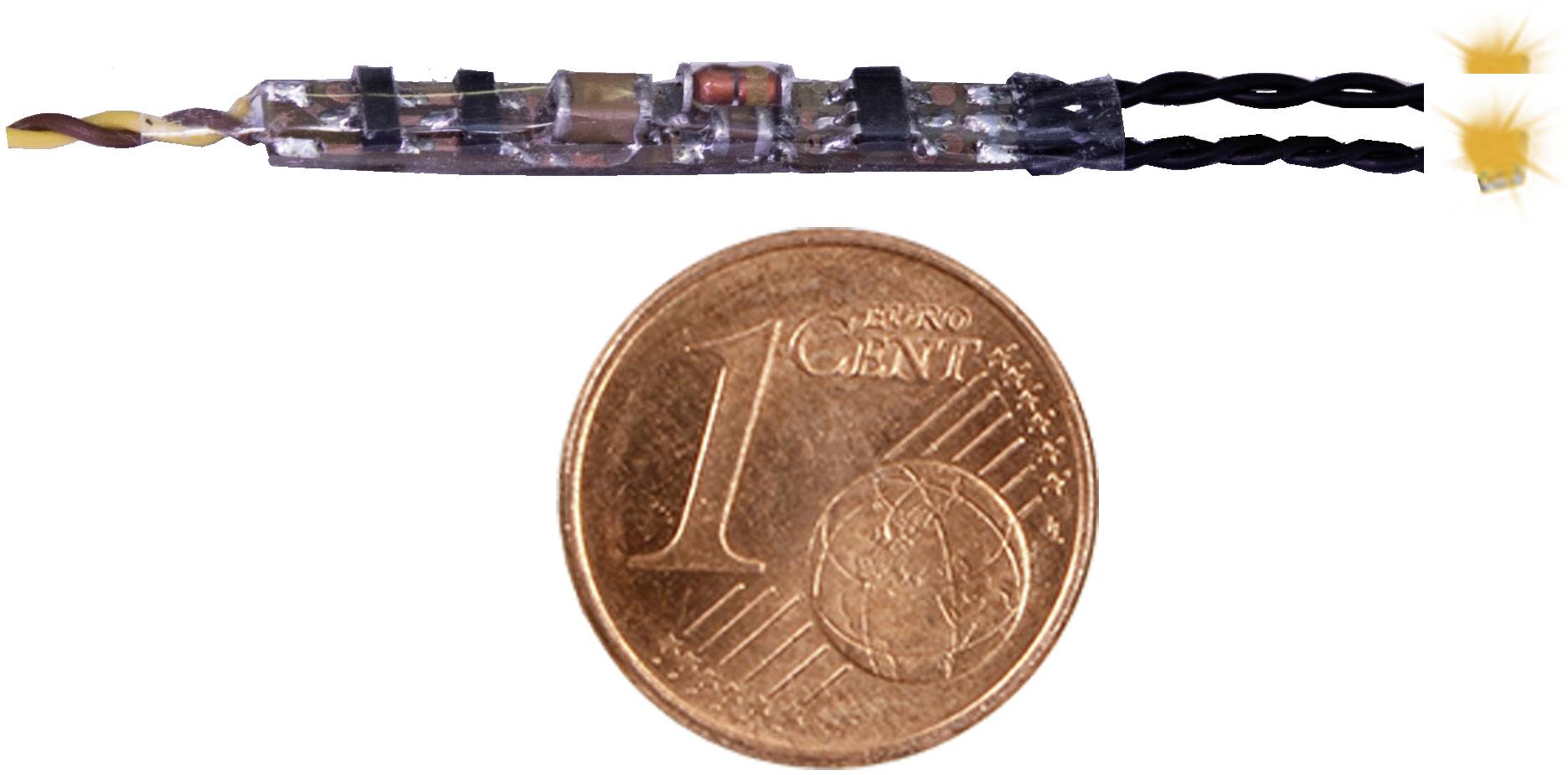 Eine winzige elektronische Komponente liegt neben einer 1-Cent-Münze als Vergleichsmaßstab.