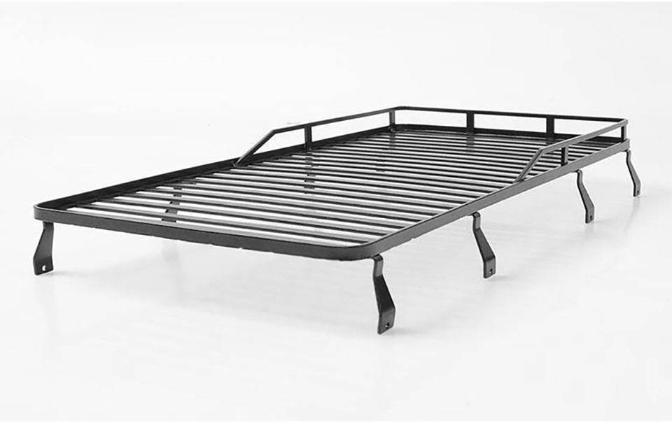 Schwarzer, flacher Dachgepäckträger aus Metall mit seitlichen Streben und erhöhter Umrandung auf weißen Hintergrund.